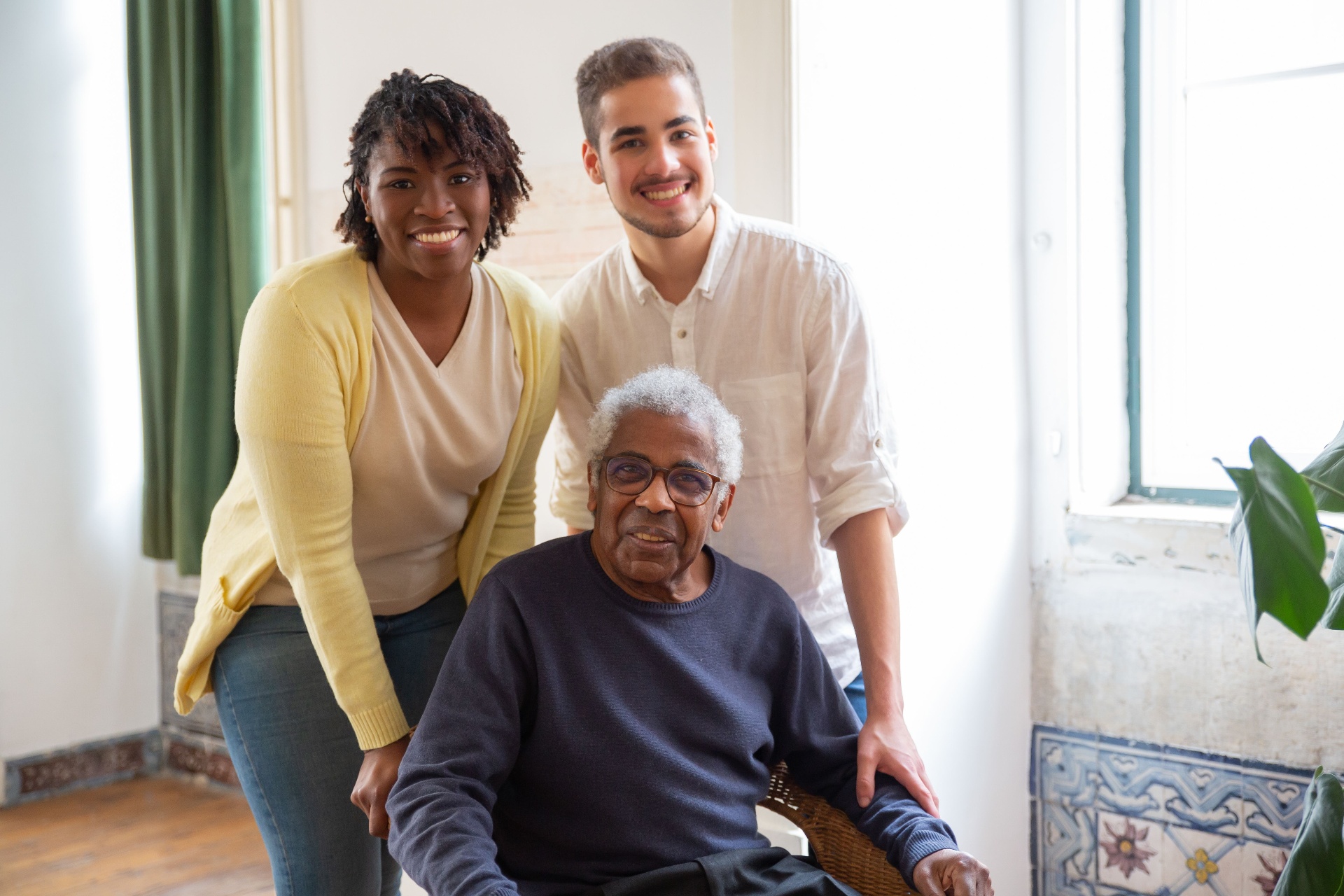Compassionate caregivers with a senior client in a warm home setting